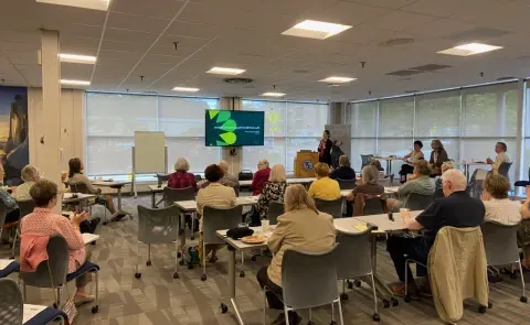 A room of workshop attendees views a presentation