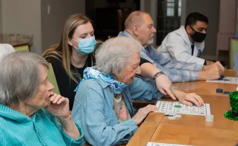 UNE health professions students play bingo with seniors at an assisted living facility